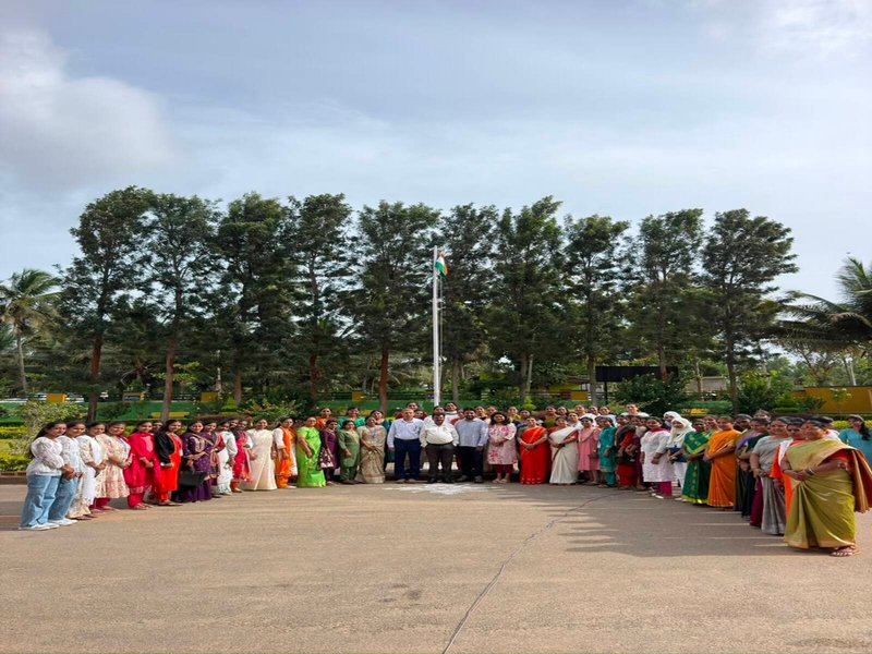 The photograph captures the Independence Day celebration at Mysuru Royal Institute of Technology (MRIT), Mandya, with the Honourable Treasurer, Dr. Ra